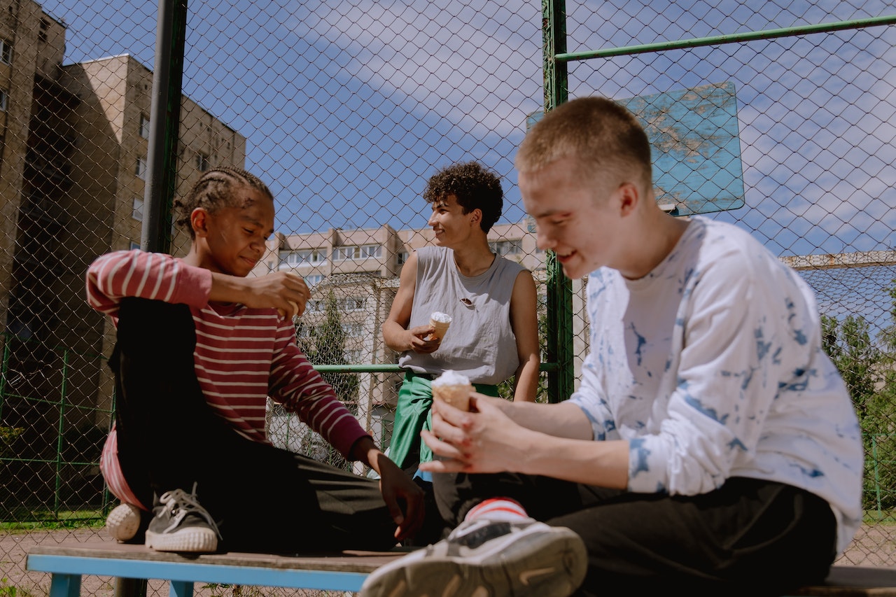 Group of teenagers eating ice cream.