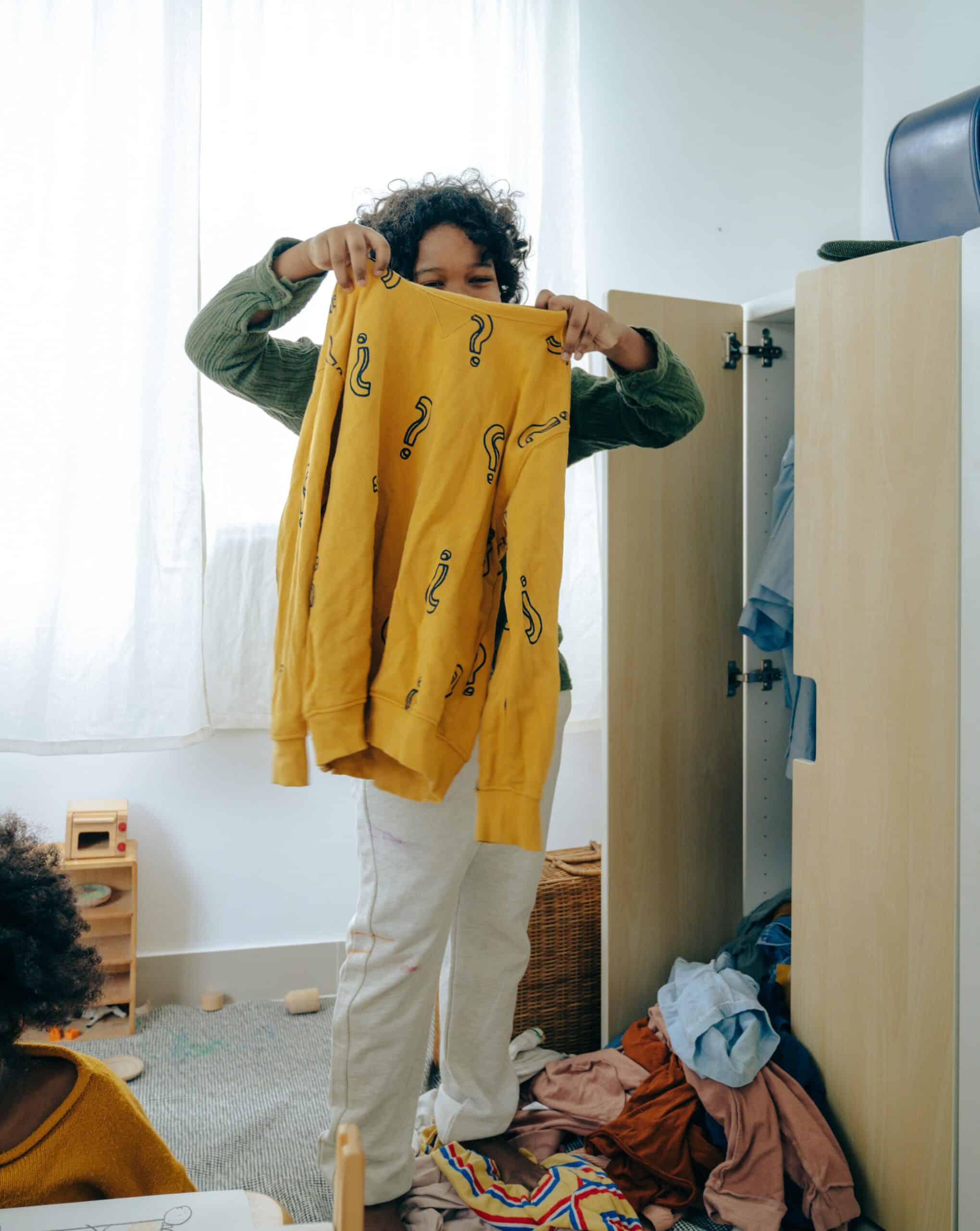 A Child choosing what to wear.