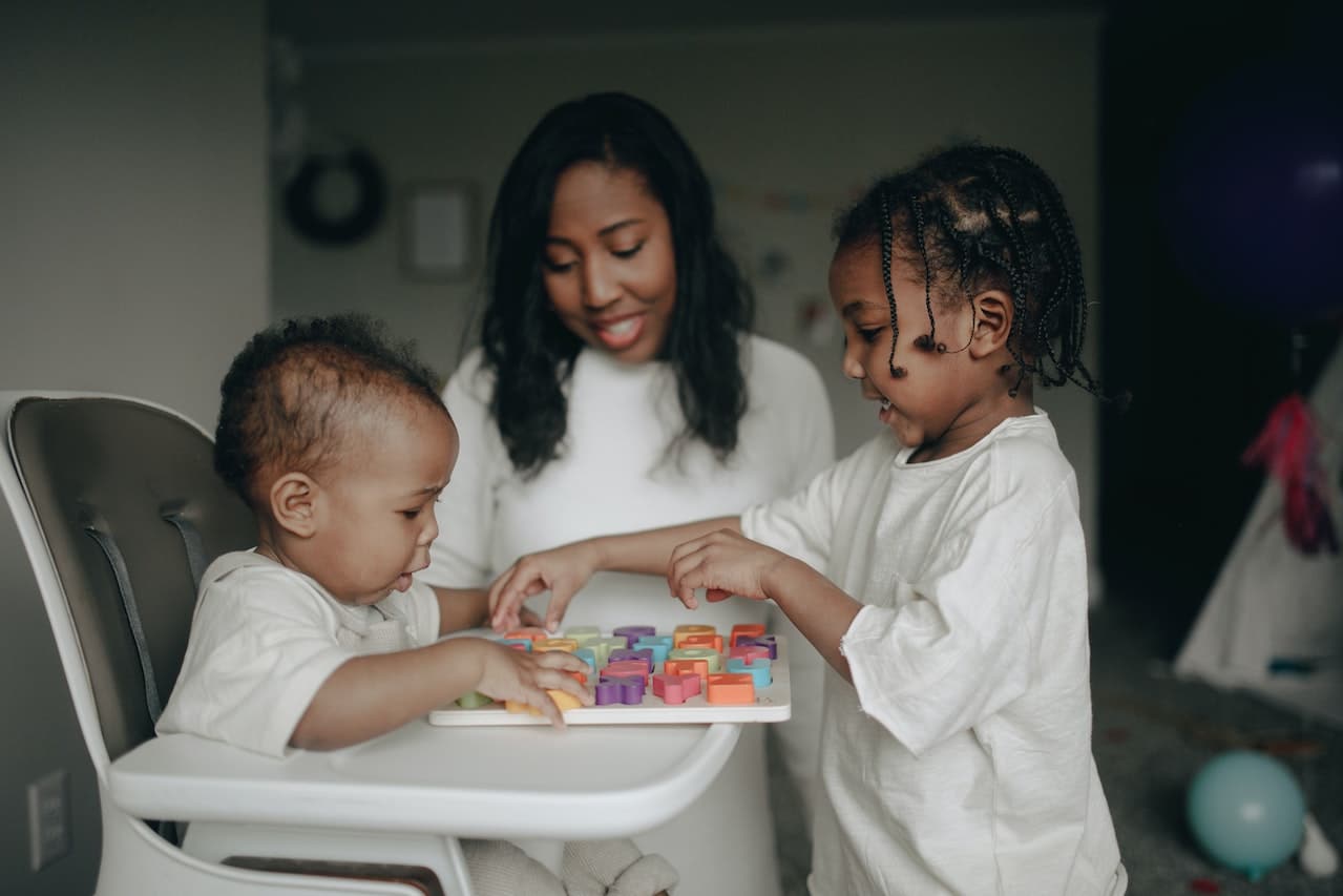 Mum and her kids playing.