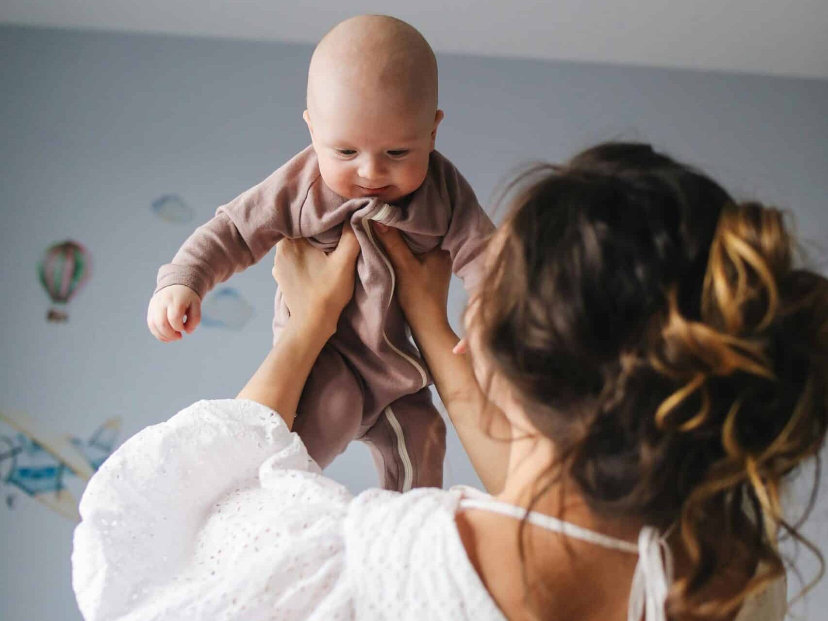 A mother plays with a toddler.