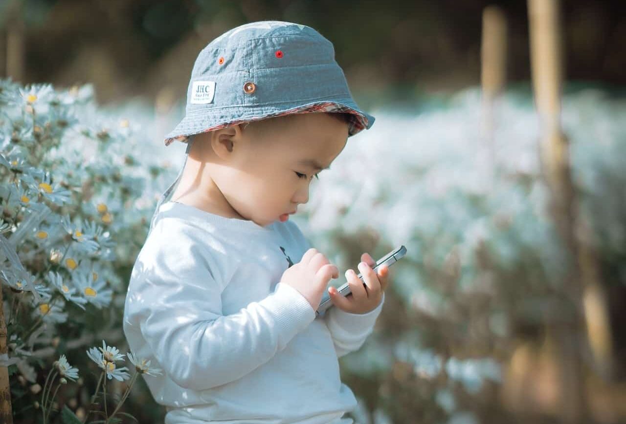 Child using iphone.