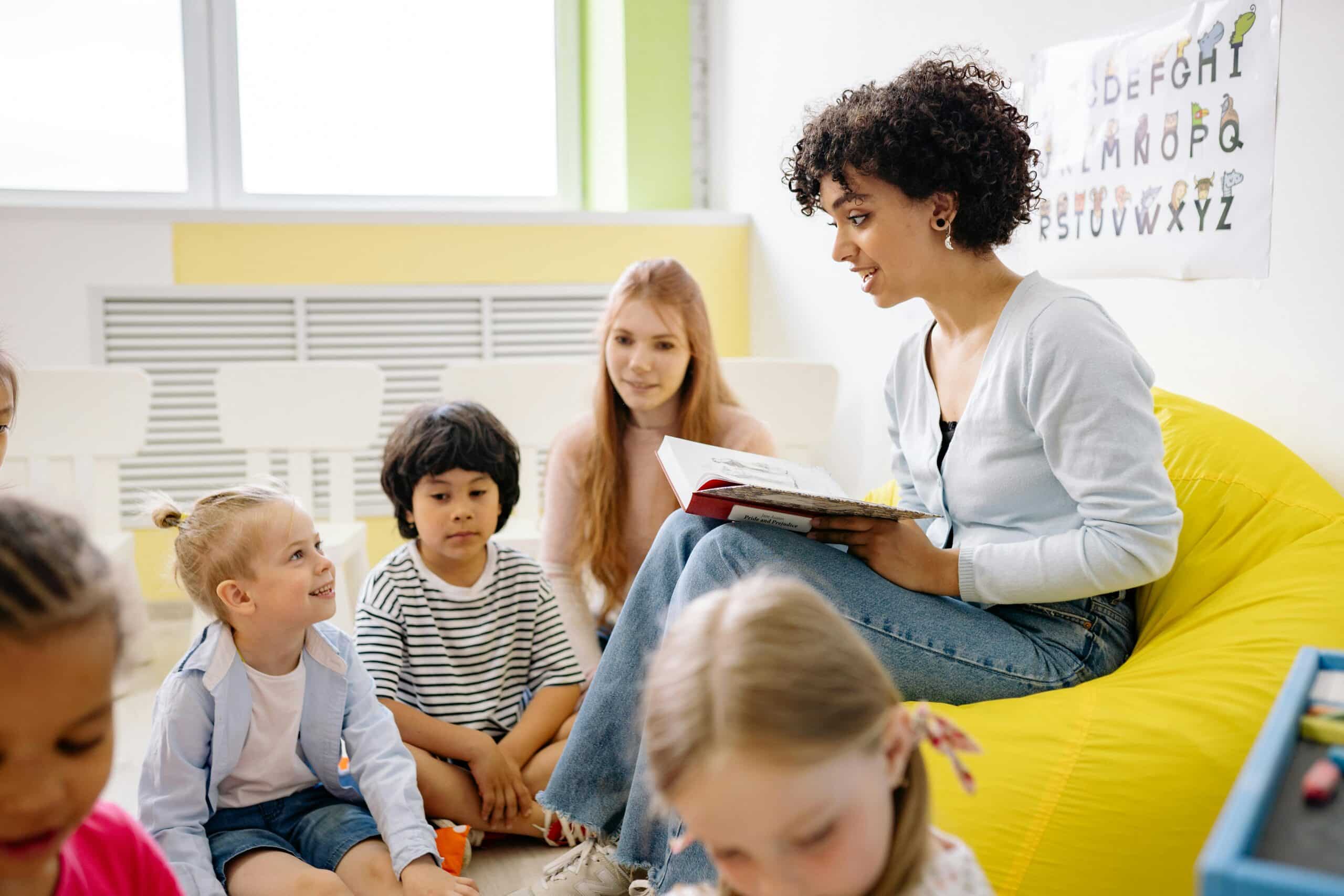 A preschool teacher reads to young children.
